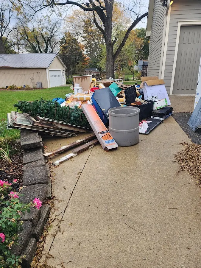 Dumpster being loaded with debris for Roofing Dumpster Rental in Saddle Brook